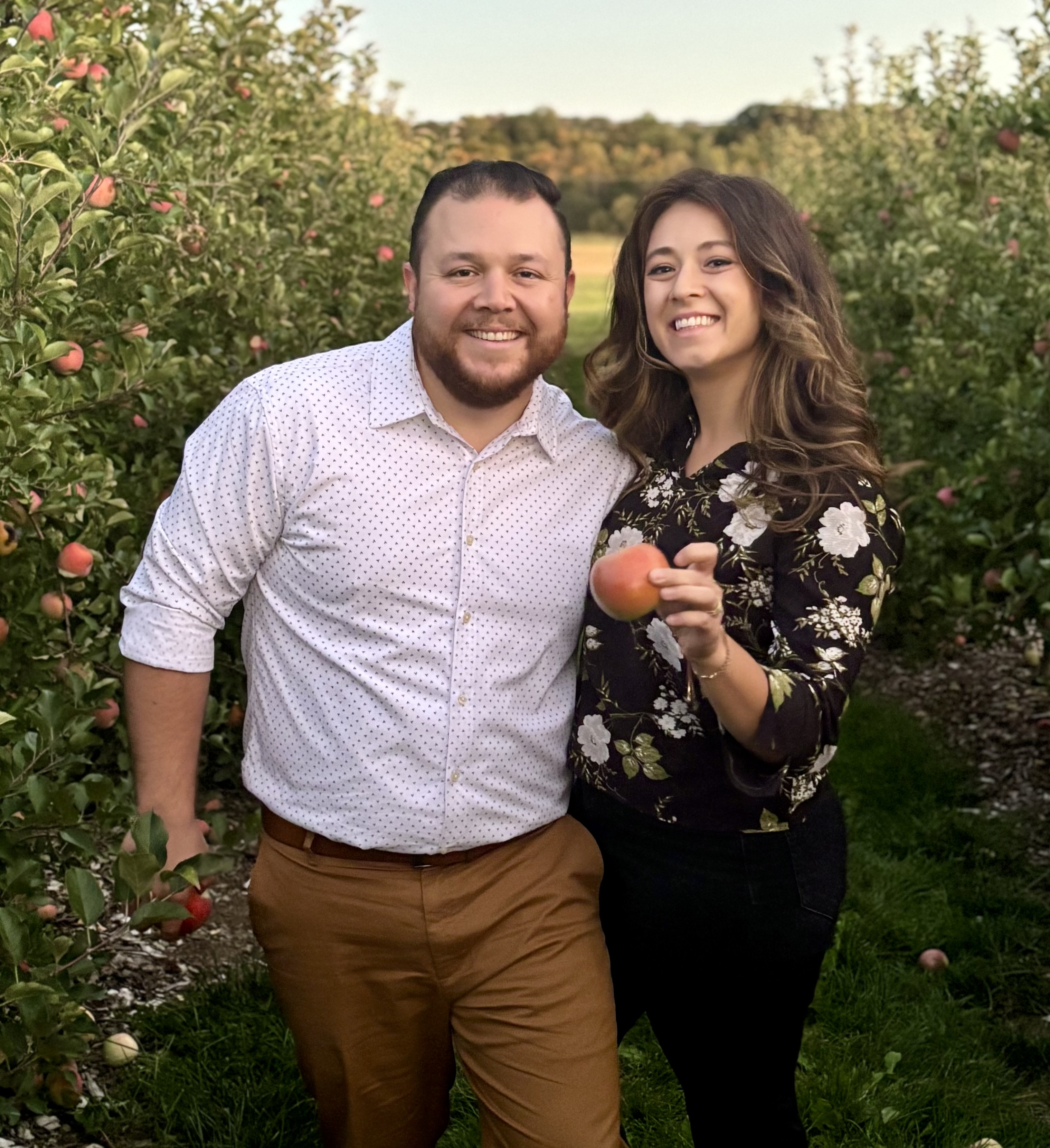 Evhan and his wife at an apple orchard